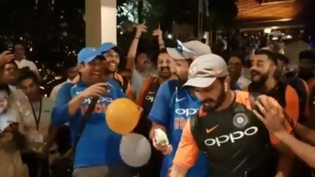 MS Dhoni laughs as Rohit Sharma and other looks on during Team India’s post match celebrations.(BCCI video screenshot)