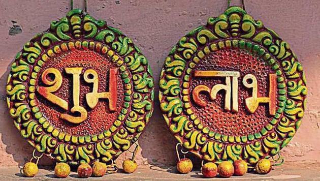 Shubh-Labh wall hanging is priced at ₹40. It is usually hung above the main entrance door to ward off evil. (Shivam Saxena/HT) Shubh-Labh wall hanging is priced at ₹40. It is usually hung above the main entrance door to ward off evil. (Shivam Saxena/HT)