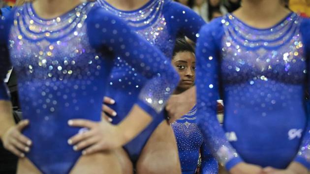 Simone Biles of the US rests behind team mates during qualifying sessions for the Gymnastics World Chamionships at the Aspire Dome in Doha, Qatar. (Vadim Ghirda / AP)