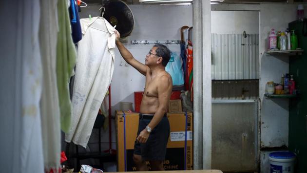 Lam, 68, hangs a towel to dry in the men’s changing room at the Sai Wan Swimming Shed. He is part of a tightly-knit community of around 50 mostly elderly citizens who are regular visitors to Sai Wan Swimming Shed, tucked away off a steep hill, providing basic changing rooms and showers. (REUTERS / Hannah McKay) Lam, 68, hangs a towel to dry in the men’s changing room at the Sai Wan Swimming Shed. He is part of a tightly-knit community of around 50 mostly elderly citizens who are regular visitors to Sai Wan Swimming Shed, tucked away off a steep hill, providing basic changing rooms and showers. (REUTERS / Hannah McKay)
