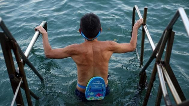 A man prepares for a morning swim. Most of the swimmers say the exercise keeps them healthy, although they have noticed changes in water quality over the decades. (REUTERS / Hannah McKay) A man prepares for a morning swim. Most of the swimmers say the exercise keeps them healthy, although they have noticed changes in water quality over the decades. (REUTERS / Hannah McKay)
