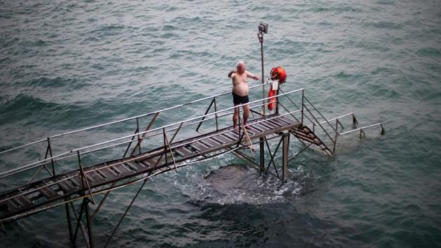 The residents, many of who have been swimming there for decades, plunge into the waters from steps reached by a spindly wooden bridge propped up on the rocks. (REUTERS / Hannah McKay) The residents, many of who have been swimming there for decades, plunge into the waters from steps reached by a spindly wooden bridge propped up on the rocks. (REUTERS / Hannah McKay)