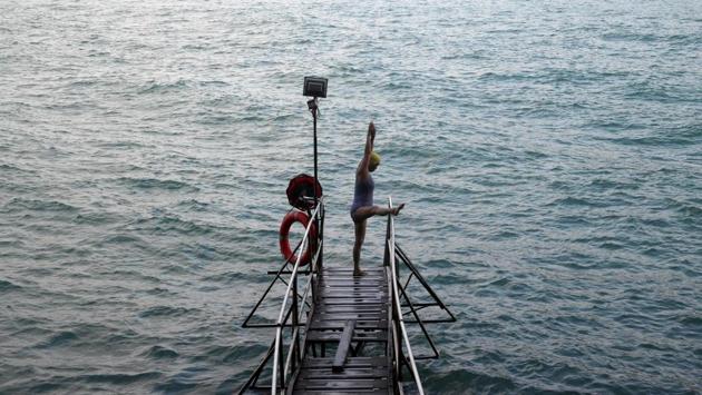 A woman prepares to swim at the Sai Wan Swimming Shed. “I’ve been coming here for 40 years, every single day,” said 83-year-old Yin Sing. “I walk up the hill to come here, even on a Sunday.” (REUTERS / Hannah McKay) A woman prepares to swim at the Sai Wan Swimming Shed. “I’ve been coming here for 40 years, every single day,” said 83-year-old Yin Sing. “I walk up the hill to come here, even on a Sunday.” (REUTERS / Hannah McKay)