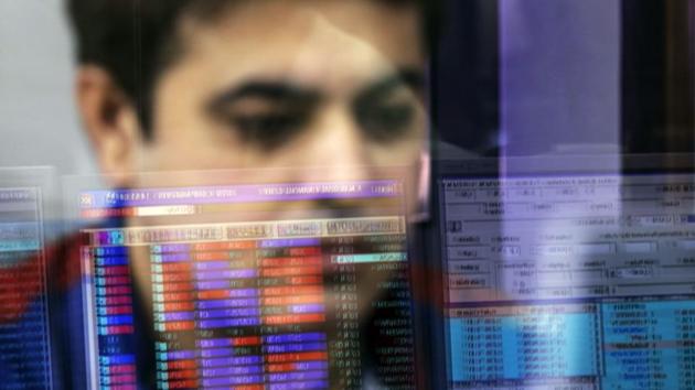 An employee is reflected in a glass panel as he monitors securities on a computer monitor at a brokerage firm in Mumbai. (Bloomberg) An employee is reflected in a glass panel as he monitors securities on a computer monitor at a brokerage firm in Mumbai. (Bloomberg)