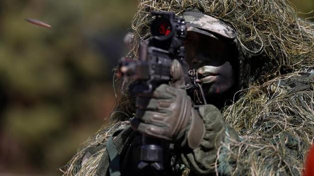A South Korean marine in action during their regular drill on Yeonpyeong Island, South Korea. (Jeon Heon-Kyun / Pool via REUTERS)