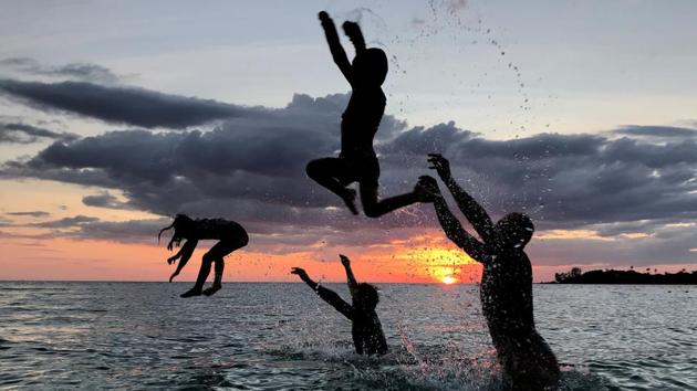 People have fun on a beach during sunset at Ko Kut island in Trat Province, Thailand. (Jorge Silva / REUTERS)