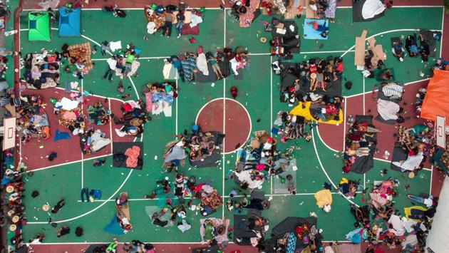 Aerial view of Honduran migrants heading in a caravan to the US, resting in a basketball pitch in San Pedro Tapanatepec, Oaxaca state, southern Mexico. (Guillermo Arias / AFP)