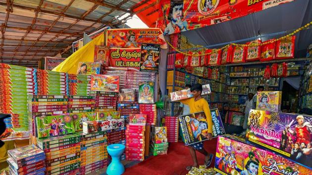 Retailers arrange crackers in their shop for sale ahead of Diwali festival celebrations, in Chennai.(PTI Photo)