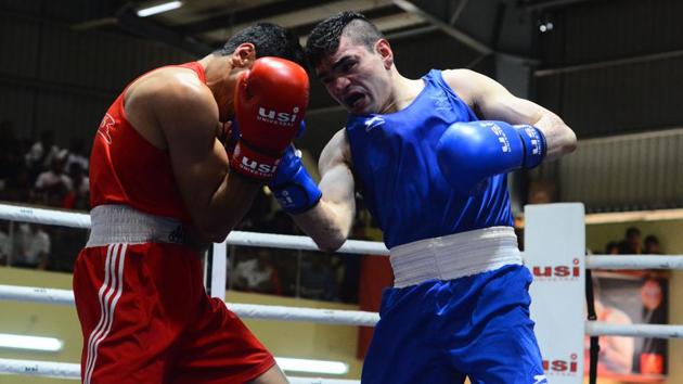 Dinesh(red)Duryodhan Singh Negi(blue)during the finals of national boxing championship in Pune,on Friday. (Shankar Narayan/HT PHOTO) 