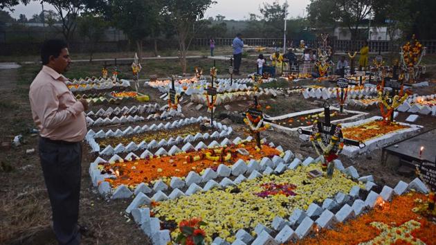 A man prays in front of his relative’s grave. Catholic devotees pay their respects and decorate the graves of a deceased family members at a cemetery in Wadagaon Sheri during All Souls Day in Pune,on Friday. (Shankar Narayan/HT PHOTO) 