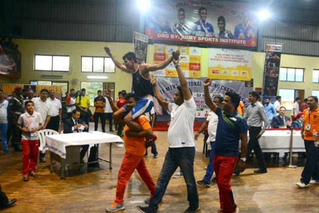 Anantha Chopde gets emotional after losing to PL Prasad as his coach lifts and cheers him during the finals of national boxing championship in Pune, India, on Friday. (Shankar Narayan/HT PHOTO) 