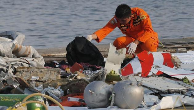 Indonesian rescue workers inspect debris believed to be from the Lion Air passenger jet that crashed off Java Island.(AP)