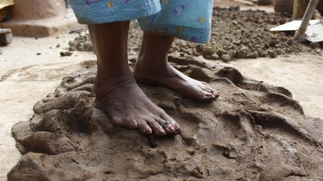 Mixed with water, the clay is kneaded with hands and feet to get an even dough. The right consistency is the key. Too hard, it won’t take shape, too soft it would break on the wheel. (Yogendra Kumar / HT Photo) Mixed with water, the clay is kneaded with hands and feet to get an even dough. The right consistency is the key. Too hard, it won’t take shape, too soft it would break on the wheel. (Yogendra Kumar / HT Photo)