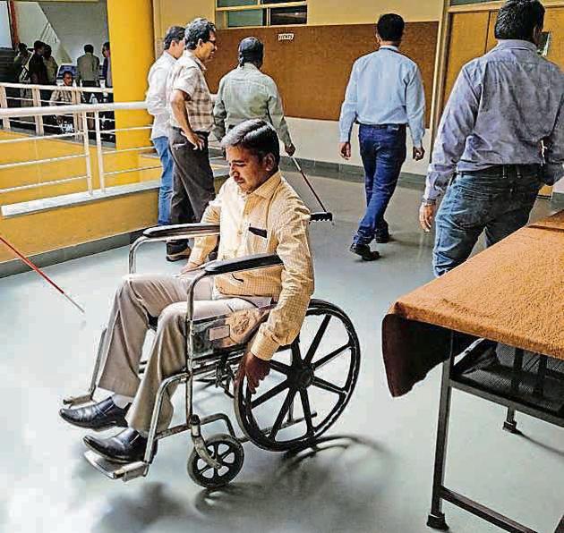 A PMC official during the workshop. In a role play officials were made to experience difficulties faced by disabled people.(HT PHOTO) A PMC official during the workshop. In a role play officials were made to experience difficulties faced by disabled people.(HT PHOTO)