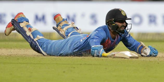 India's Dinesh Karthik dives to make it successfully to the crease during the first Twenty20 international cricket match between India and West Indies in Kolkata. (AP)