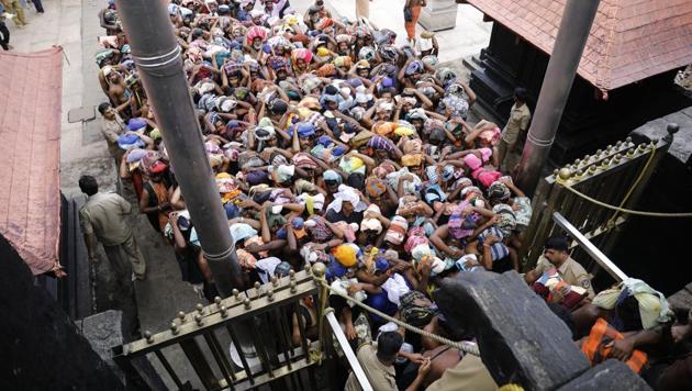 Devotees enter inside Lord Ayyappa Temple as the gates open in Sabarimala on October 17.(HT Photo/Vivek Nair)