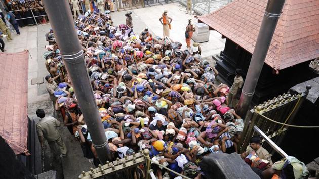 Devotees in the Lord Ayyappa Temple in Sabarimala on October 17, 2018. With the Lord Ayyappa shrine opening for a day on Monday, the temple town has been virtually taken over by some 2,300 Kerala Police personnel. (Vivek Nair/HT Photo) Devotees in the Lord Ayyappa Temple in Sabarimala on October 17, 2018. With the Lord Ayyappa shrine opening for a day on Monday, the temple town has been virtually taken over by some 2,300 Kerala Police personnel. (Vivek Nair/HT Photo)