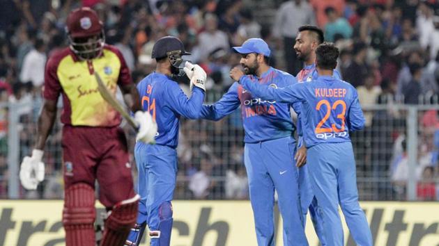 Indian players celebrate the fall of a Windies wicket at the Eden Gardens on Sunday.(AP) Indian players celebrate the fall of a Windies wicket at the Eden Gardens on Sunday.(AP)