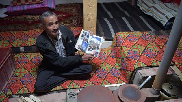 Baig shows a photo album at his home in Shimshal. Mountaineering experts agree there is a disparity and believe the Pakistani workers should be better trained and supported by the government. German mountaineer Christiane Fladt, who wrote a book on Shimshal, says the Pakistani porters “should organise themselves in a union in order to put stress on their financial demands”. (Aamir Qureshi / AFP) 