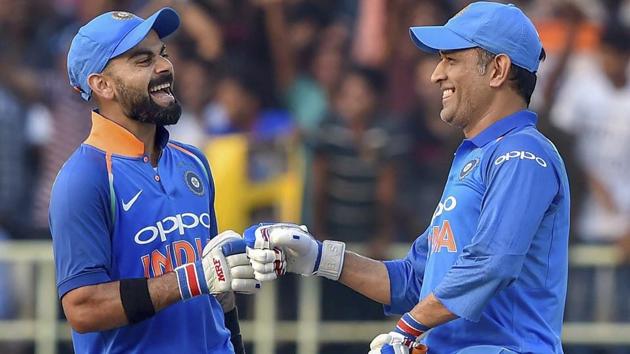 Virat Kohli and MS Dhoni celebrate after the former completed his complete 10,000 ODI runs during the 2nd ODI against West Indies.(PTI)