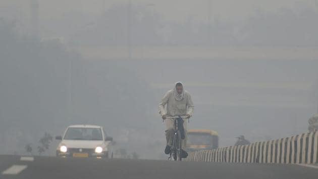 A cyclist rides through heavy haze, in New Delhi on Monday. According to the officials, pollution levels have sharply spiked today as a thick haze engulfed the national capital, ahead of Diwali, due to high impact of stubble burning that has pushed the air quality to the 'very poor' category.(PTI)