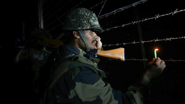 A Border Security Force (BSF) soldier holds a candle while patrolling along the fence at the International border during Diwali celebrations on the outskirts of Jammu. (PTI) A Border Security Force (BSF) soldier holds a candle while patrolling along the fence at the International border during Diwali celebrations on the outskirts of Jammu. (PTI)
