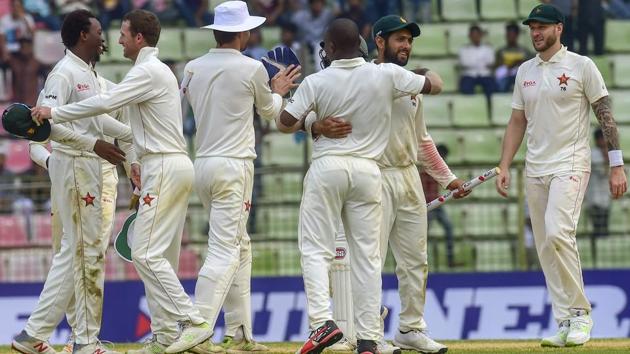 Zimbabwe cricketers celebrate after winning the match on the fourth day of the first Test against Bangladesh.(AFP)