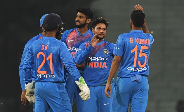 Indian cricketer Kuldeep Yadav (2R) celebrates with teammates after taking the wicket of West Indies cricketer Nicolas Pooran (not pictured) during the second T20 cricket match between India and West Indies at the Bharat Ratna Atal Bihari Vajpayee Ekana Cricket Stadium in Lucknow. (AFP)