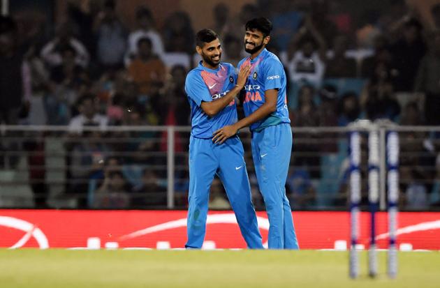 Indian cricketer Khaleel Ahmed (R) celebrates with teammate Bhuvneshwar Kumar (L) after dismissing West Indies cricketer Shai Hope (not pictured) during the second T20 cricket match between India and West Indies at the Bharat Ratna Atal Bihari Vajpayee Ekana Cricket Stadium in Lucknow. (AFP)