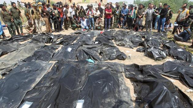 In this file photo taken on April 12, 2015, Iraqis mourn near body-bags containing the remains of people believed to have been slain by jihadists of the Islamic State (IS) group lying on the ground at the Speicher camp in the Iraqi city of Tikrit.(AFP)