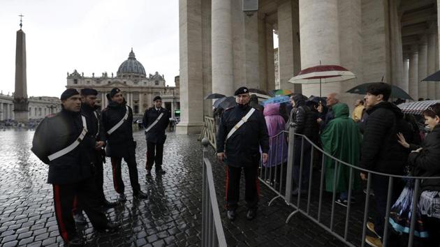 Italian Carabinieri, paramilitary policemen, patrol in St. Peter's Square as faithful line up to pass through security checks at the Vatican. From the Vatican to the Great Synagogue of Sydney, armed guards provide earthly protection for worshippers. And still an unexpected noise can send a spasm of fear through a congregation. (Gregorio Borgia / AP)
