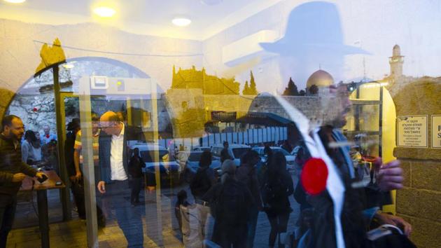 People go through a security check so they can enter the Western Wall. There is a security checkpoint to reach the Wall, the holy site of prayer in Jerusalem’s Old City. Shiite pilgrims in Iraq, whether on their way to Basra or performing rituals in Karbala, are surrounded by uniformed soldiers. (Oded Balilty / AP)