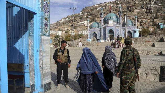 Afghan security guard the gate of the Karti Sakhi shrine in Kabul, Afghanistan. In Denmark, a Jewish security guard protecting the main synagogue was shot to death in 2015 after blocking an Islamic extremist gunman trying to get inside. Guards are routinely posted outside services and rituals for a variety of religions in Afghanistan and Pakistan, yet still attackers find ways to kill. (Rahmat Gul / AP)