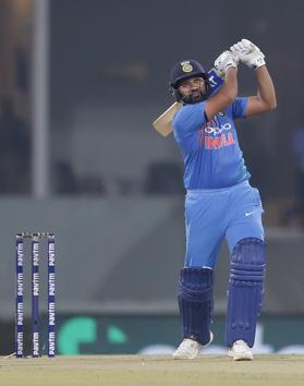 India's Rohit Sharma watches the ball after hitting it for a six during the second Twenty20 international cricket match between India and West Indies at Bharat Ratna Shri Atal Bihari Vajpayee Ekana Cricket Stadium in Lucknow. (AP)