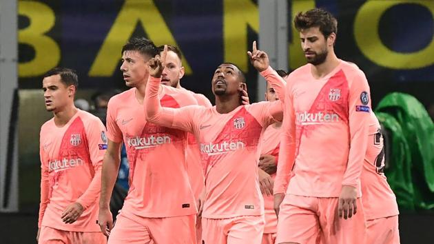 Barcelona's Brazilian midfielder Malcom (centre) celebrates after opening the scoring during the UEFA Champions League group B football match between Inter Milan and Barcelona.(AFP)