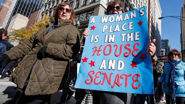 A woman holds a sign during a rally and march on in Chicago to inspire voter turnout ahead of midterm elections in the US.(AFP File) A woman holds a sign during a rally and march on in Chicago to inspire voter turnout ahead of midterm elections in the US.(AFP File)