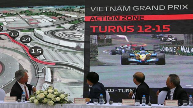 President and CEO of Formula 1 Chase Carey, left, Hanoi Mayor Nguyen Duc Chung, second from left and two other officials watch the Hanoi F1 circuit design.(AP)