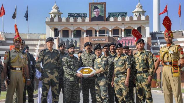 Pakistani border wing commander Usman Khalid (L) exchanges sweets with his Indian counterparts Border Security Force Commandant Sudeep on the occasion of the Diwali at the India-Pakistan Wagah border near Amritsar. (PTI) Pakistani border wing commander Usman Khalid (L) exchanges sweets with his Indian counterparts Border Security Force Commandant Sudeep on the occasion of the Diwali at the India-Pakistan Wagah border near Amritsar. (PTI)