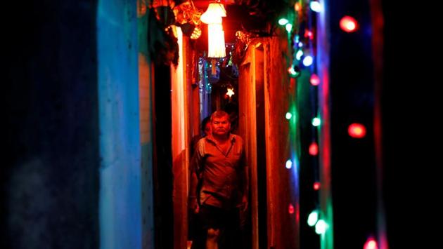Residents walk in a slum's alley illuminated by colourful lights in Mumbai. (Danish Siddiqui / REUTERS) Residents walk in a slum's alley illuminated by colourful lights in Mumbai. (Danish Siddiqui / REUTERS)