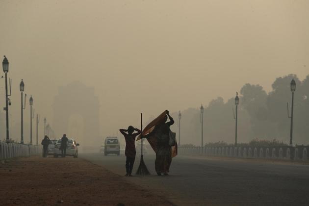India Gate in the background looks like an apparition due to the smog in Delhi, a day after Diwali (AP)