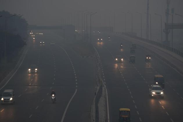 Car owners find it difficult to drive on a hazy morning causing near-zero visibility (AFP)