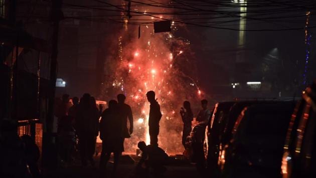 Despite a ban on crackers after 10pm, people were still observed bursting them in Patel Nagar. “In some areas, people have been found burning firecrackers beyond 8pm-10pm time frame. The exact number of violation is yet to be ascertained. But, we will take strict action against them,” an official was quoted as saying by news agency PTI on Wednesday. (Sanchit Khanna / HT Photo)