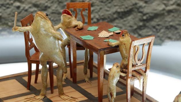 Frogs playing a family scene. What’s equally fascinating is the obviously painstaking detail Perrier put into the details of each scene, complete with miniature furniture and accoutrements.  (Denis Balibouse / REUTERS) 