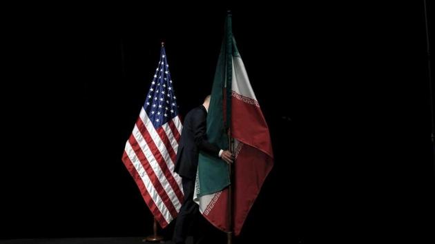 A staff member removes the Iranian flag from the stage after a group picture with foreign ministers and representatives of the US, Iran, China, Russia, Britain, Germany, France and the European Union during the Iran nuclear talks at the Vienna International Center in Vienna, Austria on July 14, 2015.(REUTERS) A staff member removes the Iranian flag from the stage after a group picture with foreign ministers and representatives of the US, Iran, China, Russia, Britain, Germany, France and the European Union during the Iran nuclear talks at the Vienna International Center in Vienna, Austria on July 14, 2015.(REUTERS)