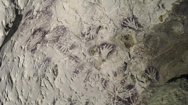 This undated photo provided by Kinez Riza shows mulberry-colored Bouquet of Hands stencil in a cave in the Indonesian part of the island of Borneo. This particular style of hand stencil dates to the height of the Last Glacial Maximum about 20,000 years ago. (Kinez Riza via AP) This undated photo provided by Kinez Riza shows mulberry-colored Bouquet of Hands stencil in a cave in the Indonesian part of the island of Borneo. This particular style of hand stencil dates to the height of the Last Glacial Maximum about 20,000 years ago. (Kinez Riza via AP)