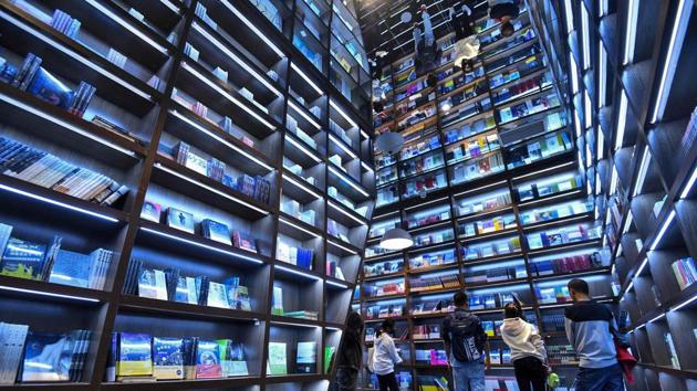 Visitors browse at a bookstore decorated with mirrors and backlit shelves to attract customers in Guiyang in China’s southwestern Guizhou province. (AFP) Visitors browse at a bookstore decorated with mirrors and backlit shelves to attract customers in Guiyang in China’s southwestern Guizhou province. (AFP)