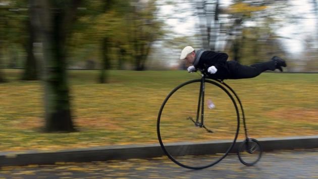 A bike enthusiast dressed in historical costume drives his penny-farthing bicycle, also known as high wheel, during the traditional ‘One Mile Race’ competition at Letna Park in Prague, Czech Republic. (Michal Cizek / AFP) A bike enthusiast dressed in historical costume drives his penny-farthing bicycle, also known as high wheel, during the traditional ‘One Mile Race’ competition at Letna Park in Prague, Czech Republic. (Michal Cizek / AFP)