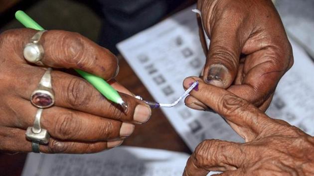 Polling officials put an ink mark on a voter's finger after during panchayat election at a polling booth in Howrah district of West Bengal.(PTI File Photo/Representative image)