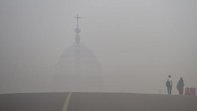 People walk on Rajpath road engulfed in thick haze, in New Delh. According to government-run agency SAFAR said that the city’s air quality would remain in the severe category till Saturday, as the already toxic situation caused by smoke from fireworks is likely to aggravate further due to intensified stubble burning in neighbouring states. (PTI) People walk on Rajpath road engulfed in thick haze, in New Delh. According to government-run agency SAFAR said that the city’s air quality would remain in the severe category till Saturday, as the already toxic situation caused by smoke from fireworks is likely to aggravate further due to intensified stubble burning in neighbouring states. (PTI)