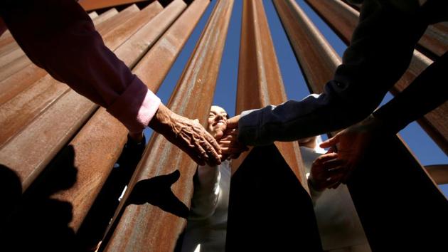 Nuns shake hands through the border fence between Ciudad Juarez and El Paso, during a binational mass in support of migrants and in memory of those who died trying to cross illegally into the US, in Ciudad Juarez, Mexico. (Jose Luis Gonzalez / REUTERS) Nuns shake hands through the border fence between Ciudad Juarez and El Paso, during a binational mass in support of migrants and in memory of those who died trying to cross illegally into the US, in Ciudad Juarez, Mexico. (Jose Luis Gonzalez / REUTERS)